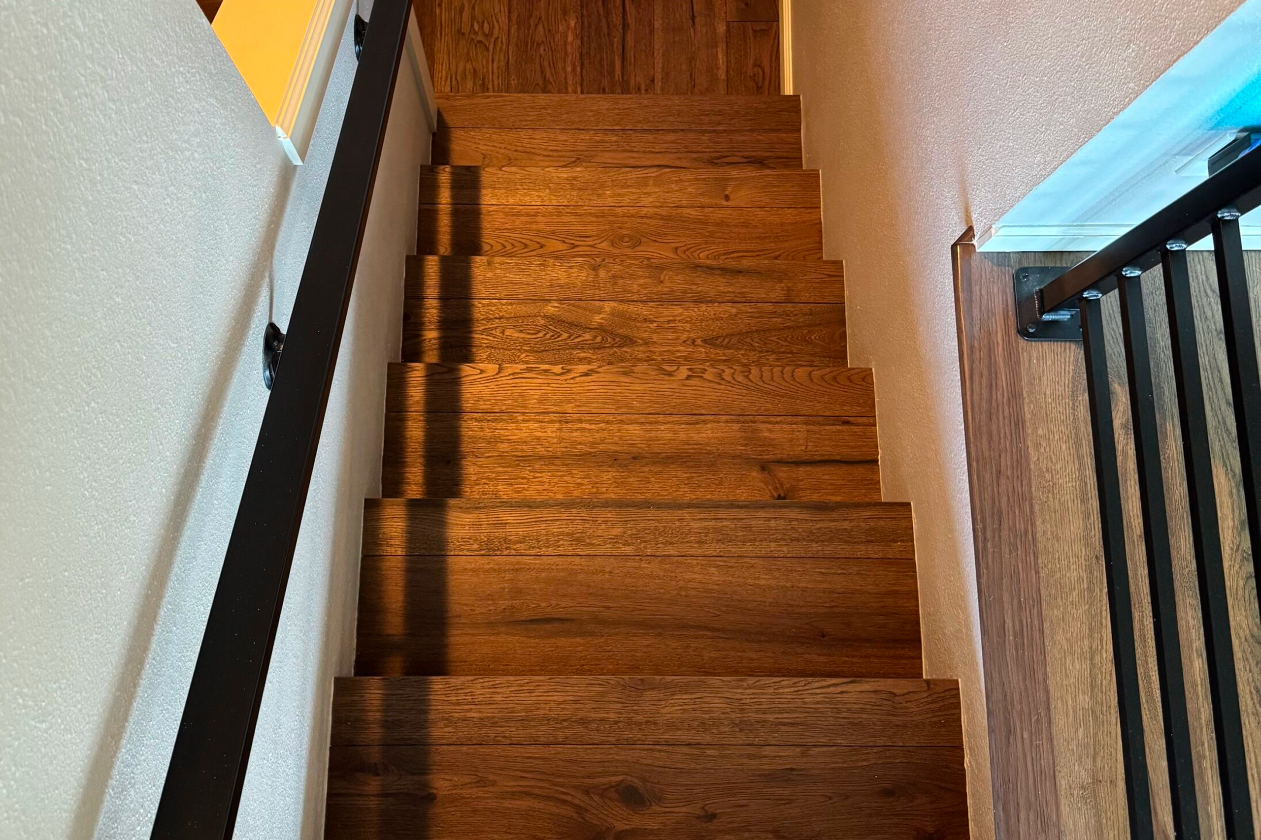 Top-down view of wooden staircase and railing