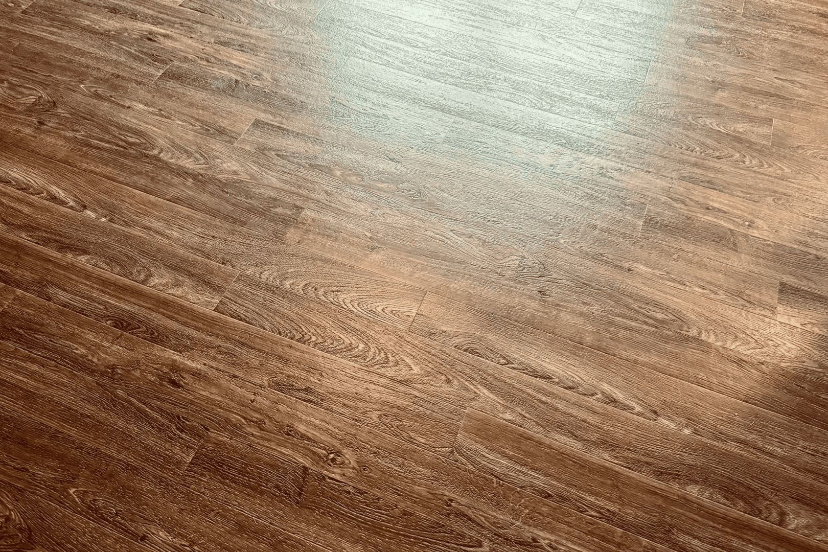 Polished brown hardwood floor with sunlight reflection