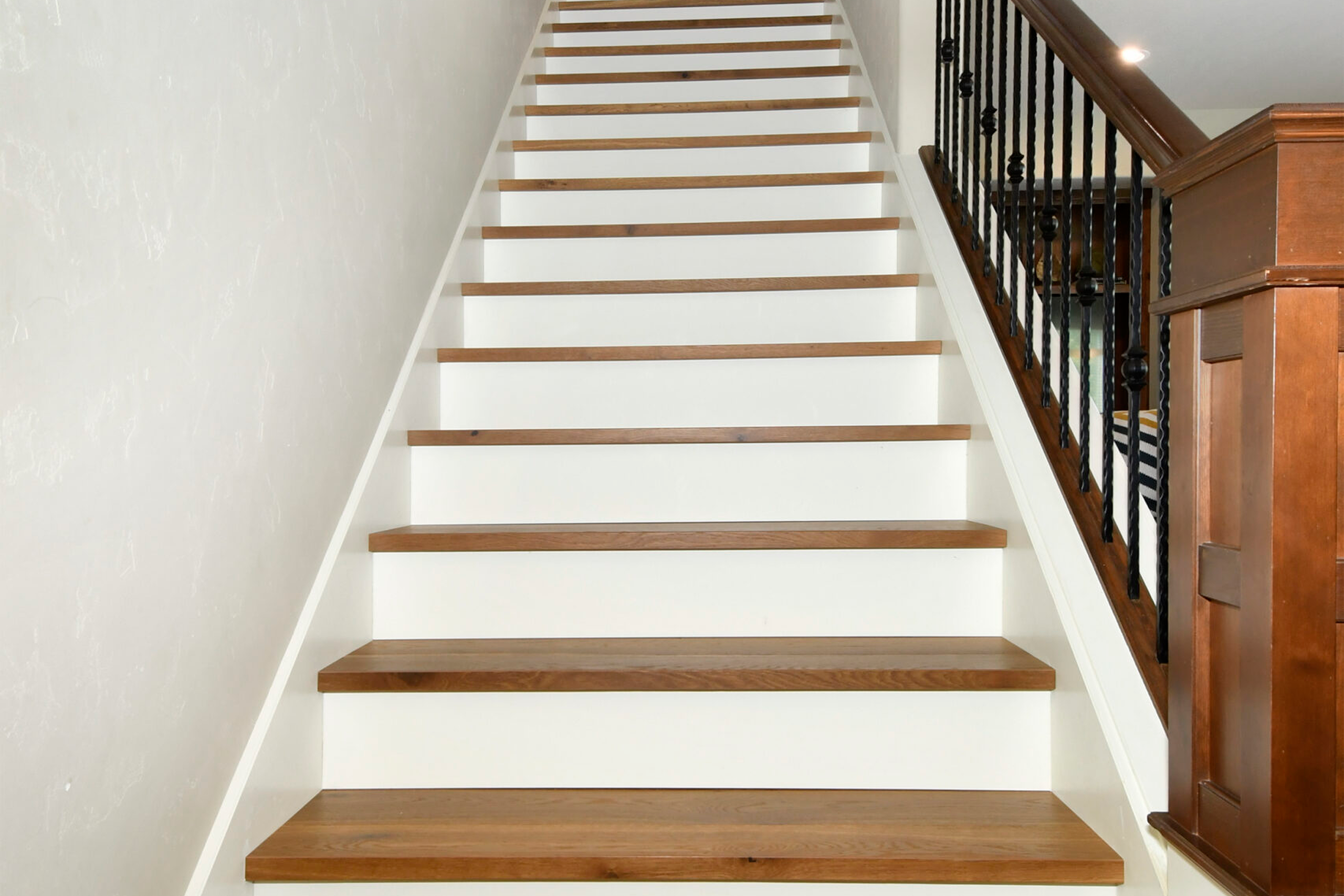 Indoor wooden staircase with white risers